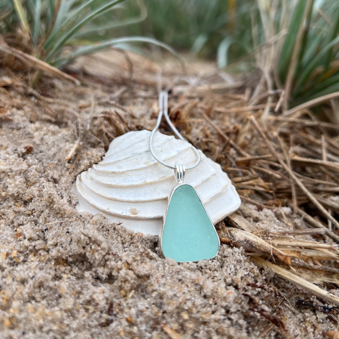 Seafoam sea glass set in silver pendant by Mornington Sea Glass. Hangs on a 40 or 45cm sterling silver snake chain.