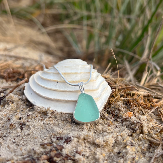 Seafoam sea glass set in silver pendant by Mornington Sea Glass. Hangs on a 40 or 45cm sterling silver snake chain.