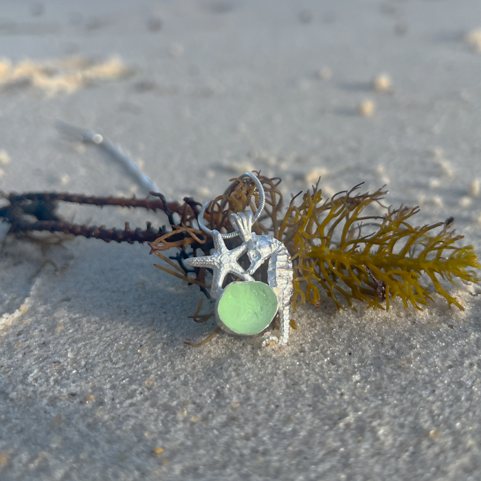 Sterling silver necklace of a small cast silver seahorse, sea star  and seafoam sea glass treasure. Hangs on a 40 or 45cm sterling silver chain. By Mornington Sea Glass.