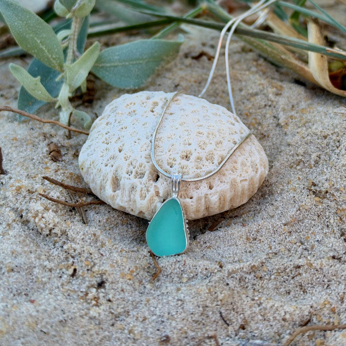 Soft green sea glass set in silver pendant by Mornington Sea Glass. hangs on a 40 or 45cm 1mm sterling silver snake chain.