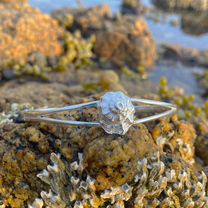 Sterling silver split centre cuff featuring a cast silver spiral shell. 60cm diameter with a 3cm opening. By Mornington Sea Glass.