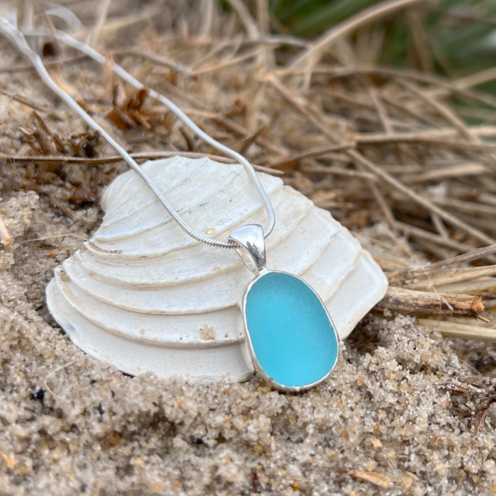 Blue sea glass set in silver pendant by Mornington Sea Glass. Hangs on a 40 or 45cm sterling silver snake chain.