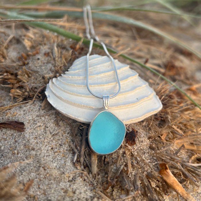 Blue sea glass set in silver pendant by Mornington Sea Glass. Hangs on a 40 or 45cm sterling silver snake chain.