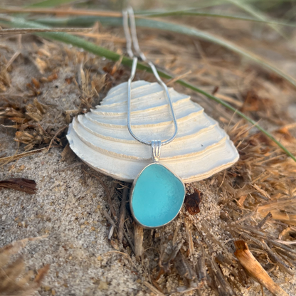 Blue sea glass set in silver pendant by Mornington Sea Glass. Hangs on a 40 or 45cm sterling silver snake chain.