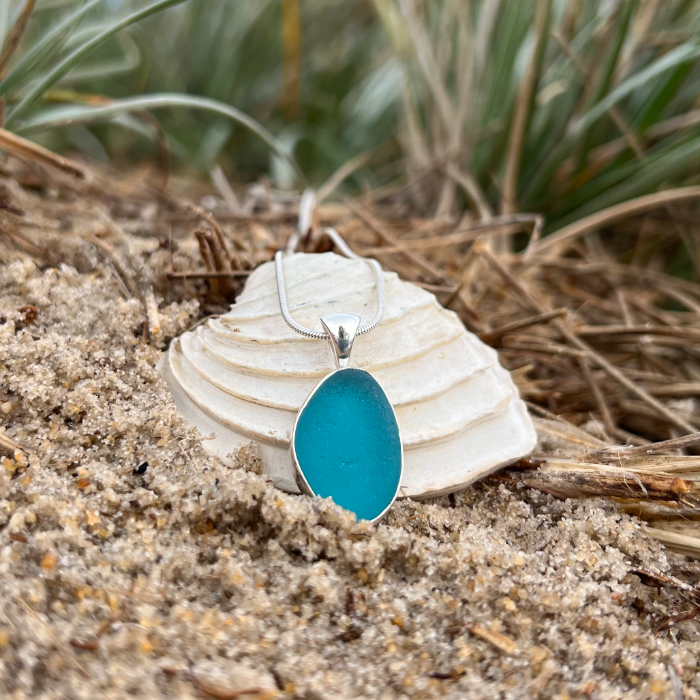 Teal sea glass set in silver pendant by Mornington Sea Glass. Hangs on a 40 or 45cm sterling silver snake chain.