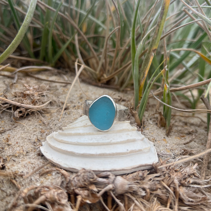 Teal blue sea glass set in silver on a hammered silver ring band by Mornington Sea Glass. Size 9 3/4