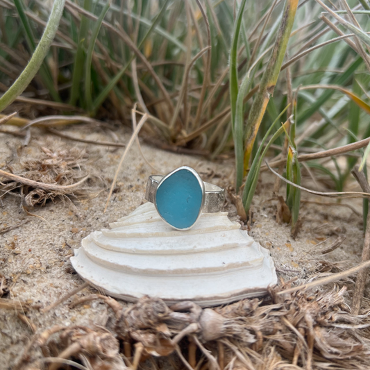 Teal blue sea glass set in silver on a hammered silver ring band by Mornington Sea Glass. Size 9 3/4