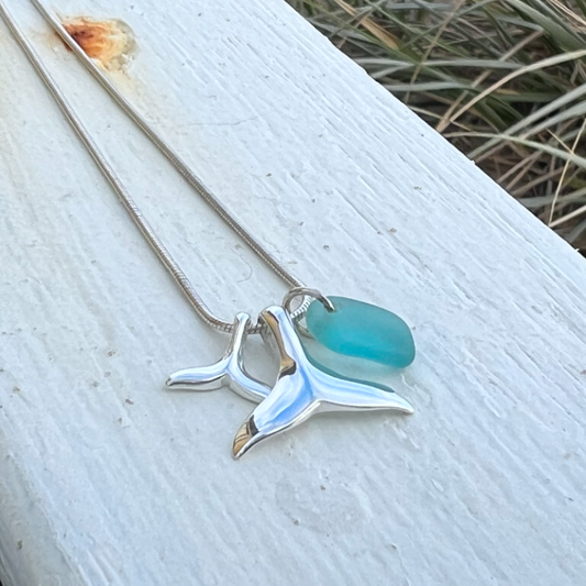 Ocean Teal sea glass and two sterling silver whale tail charms necklace by Mornington Sea Glass. Hangs on a sterling silver 40 or 45cm snake chain.