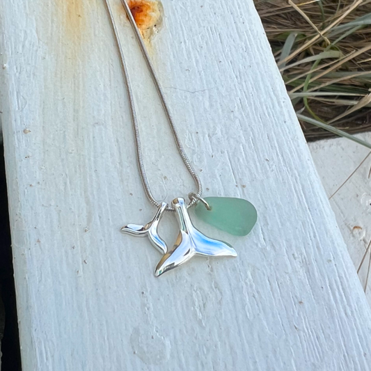 Soft seafoam green sea glass and two sterling silver whale tail charms necklace by Mornington Sea Glass. Hangs on a sterling silver 40 or 45cm snake chain.