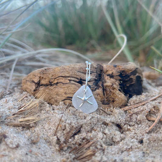 White sea glass and sterling silver starfish pendant by Mornington Sea Glass. Hangs on a 40cm + 5cm extension ball detail chain.